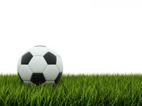 Black and white football on grass