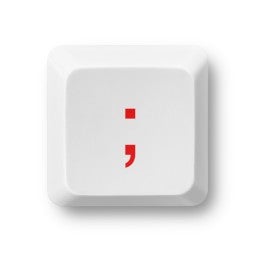 Semi-colon symbol on a computer key isolated on white